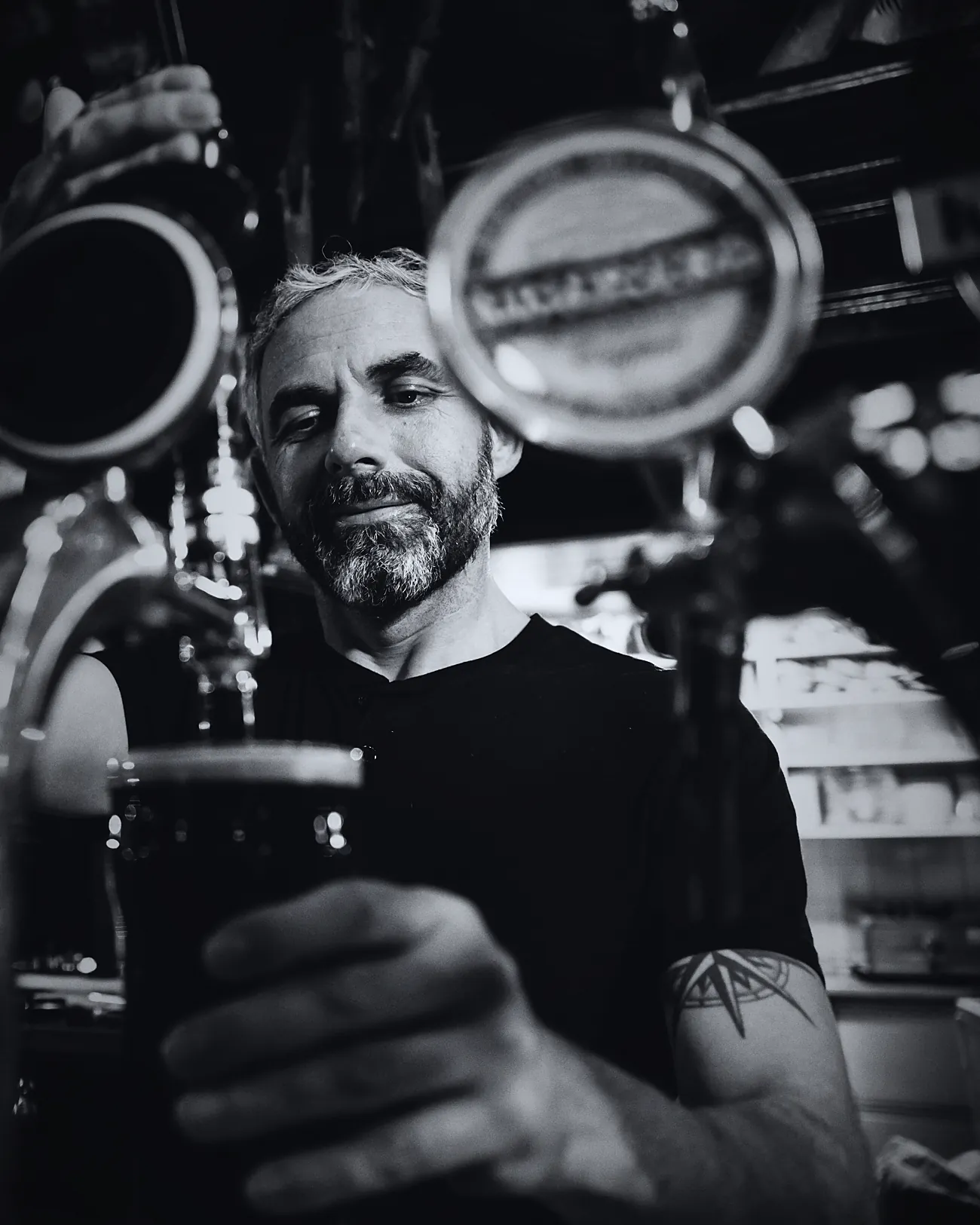 Bartender pouring behind a dark bar