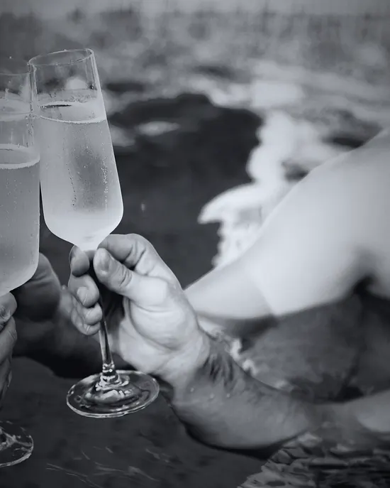 Sparkling drink held above a pool